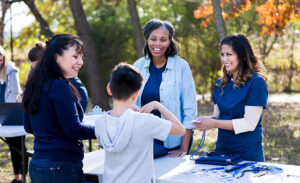 Community health workers providing health education to a boy and his mom